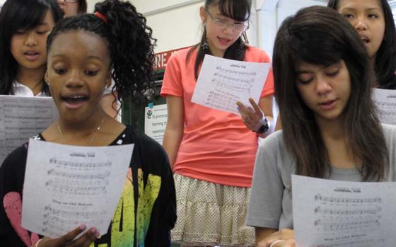 Matthew M. Burke/ Stars and Stripes 

Students in Mrs. DeEtte Hassen's chorus class for 7th- and 8th-graders and high schoolers sing Monday at the E.J. King High/Sasebo Elemantary complex at Sasebo Naval Base in southwestern Japan. Teachers in Sasebo wasted very little time in getting back to the books on the first day. School bells rang for the first time this year across the Pacific, except in Okinawa where Typhoon Bolaven led to cancellations on the first day.