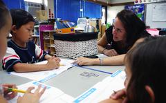 Calvin Yang listens as Cameron Gonzales, first grade/kindergarten teacher, gives instructions during the Summer Enrichment program held by Seoul American elementary and middle schools in Seoul, Thursday.