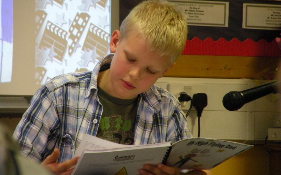 Eli Haynie reads from his book, "My High Flying Dad," during an authors tea, April 7, to honor his local hero and father, Capt. Kevin Haynie from RAF Mildenhal&#39;s 351st Air Refueling Squadron. Haynie is a student in Karen Griffis' class at Feltwell Elementary School.