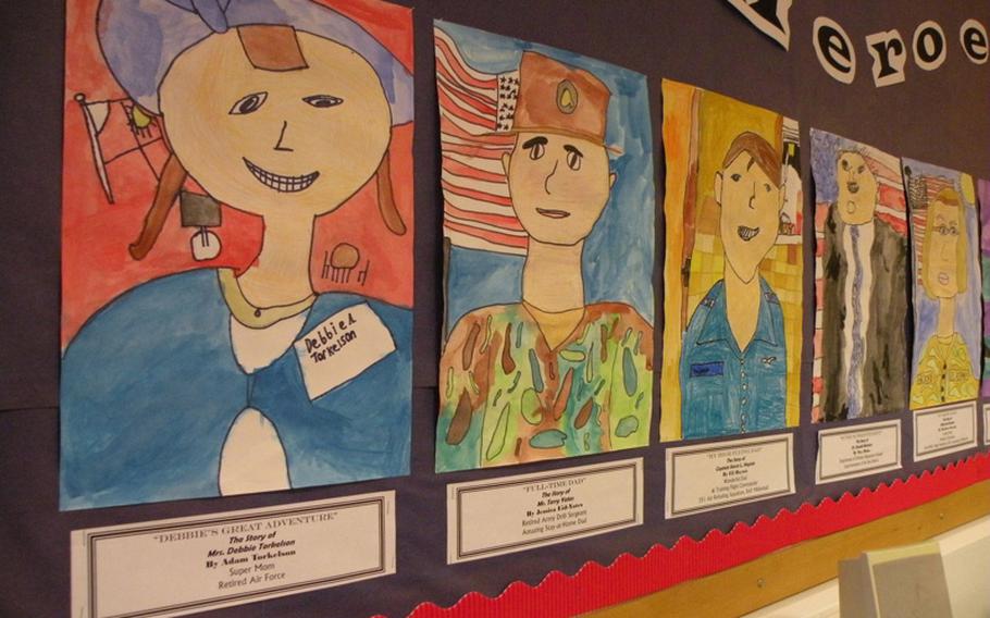 Water-color pictures adorn the walls of Karen Griffis' classroom at Feltwell Elementary School. Each student painted a picture of his or her local hero for the authors tea.