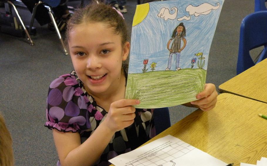 Cherish Despain holds a finished picture of her mom, Lorene Despain, created as part of a project on local heroes by members of Karen Griffis' class at Feltwell Elementary School.