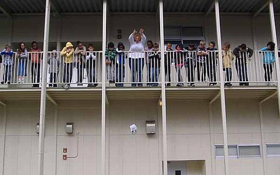 Kinser Elementary teacher Laurie Arensdorf and her fifth-grade class drop eggs to Miwa Hyatt, left, and Brenna Menting, right, from the second floor of their school in January while studying velocity, force and the benefits of protective gear. It was one of several mini-experiments the class conducted while building a game for NASA's Spaced Out Sports' contest.