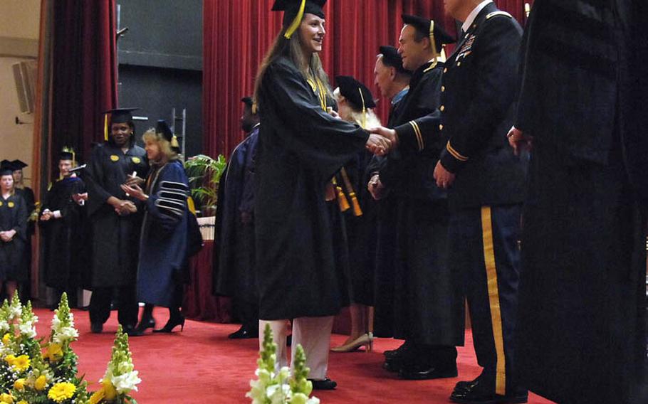 Graduates are congratulated after receiving their degrees at the University of Maryland University College Europe commencement ceremony in Heidelberg, Germany, on Saturday. Slightly more that 200 graduates attended the ceremony representing the more than 1,100 graduates of the Europe branch of the university and its partner school, Bowie State University.