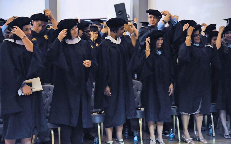 Graduates turn their tassels at the conclusion of the 2011 University of Maryland University College Europe commencement ceremony in Heidelberg, Germany, on Saturday. Slightly more that 200 of the 1,100 graduates receiving diplomas attended the ceremony.