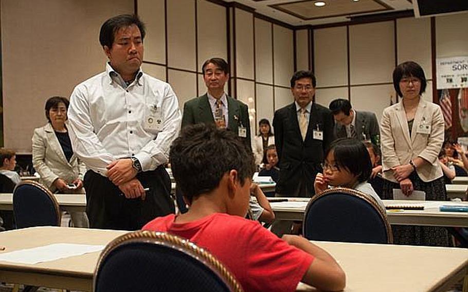 Officials monitor the finalists of the written portion of the 29th Kanto Area DODDS Soroban Contest at the New Sanno Hotel in Tokyo on Wednesday.